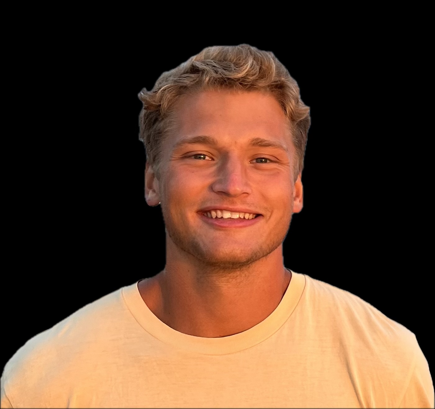 A picture of Jake Neufeld who has short light brown or dark blonde hair, wearing a white shirt, smiling with teeth showing.